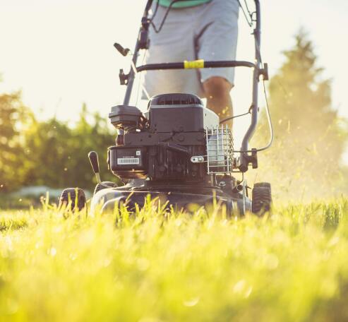 Person mowing grass